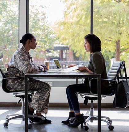 Photo of a woman and veteran consulting