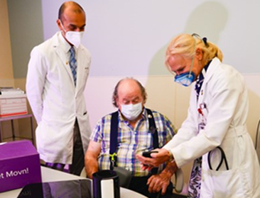 VA Doctors demonstrate a smartHEART device to a Veteran