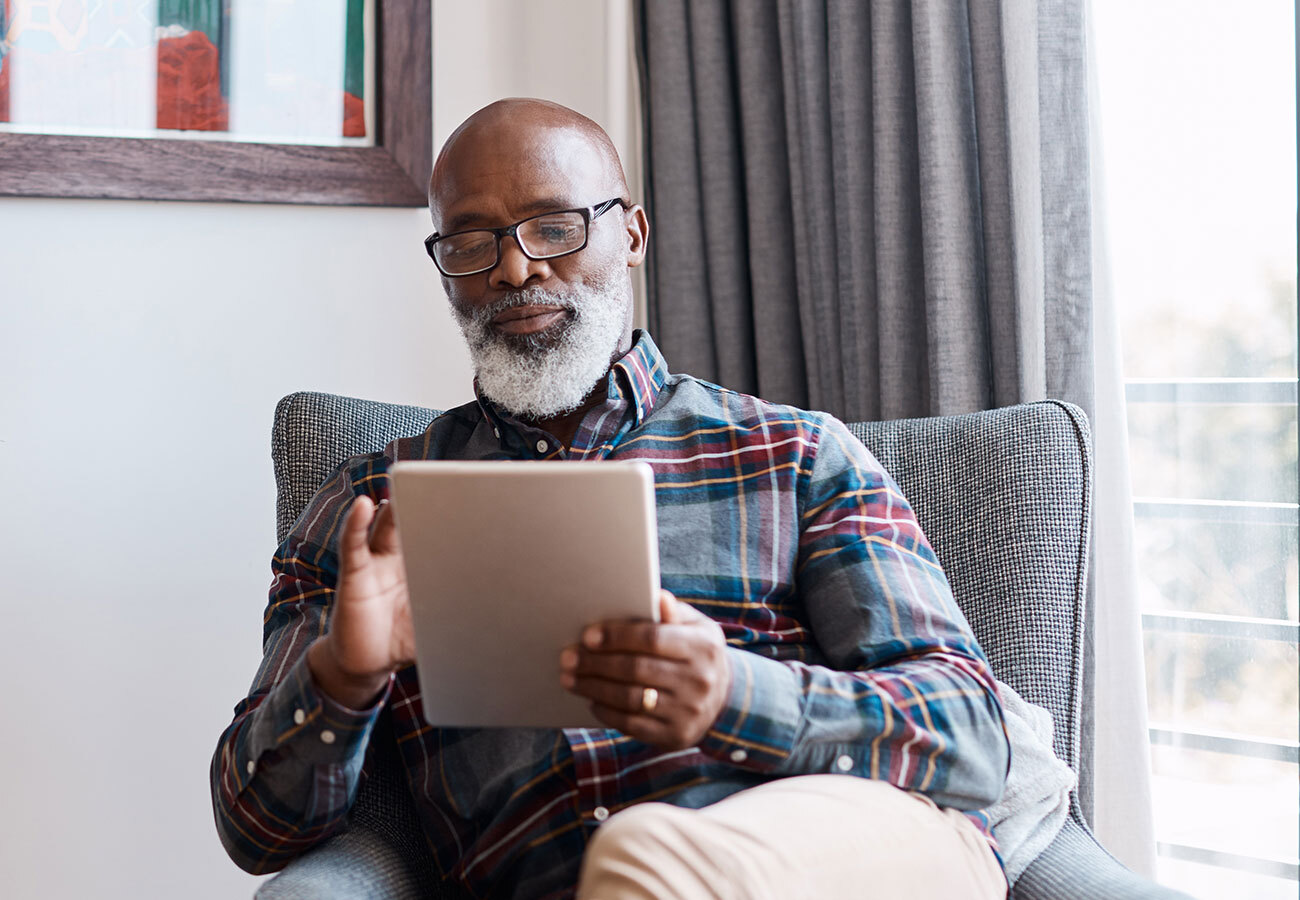 A man sitting using a tablet