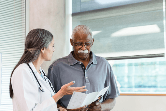 Physician assisting a military veteran in an office