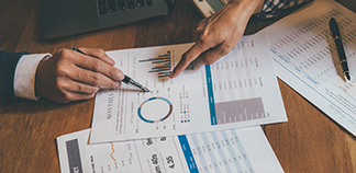 Two people analyzing data sheets