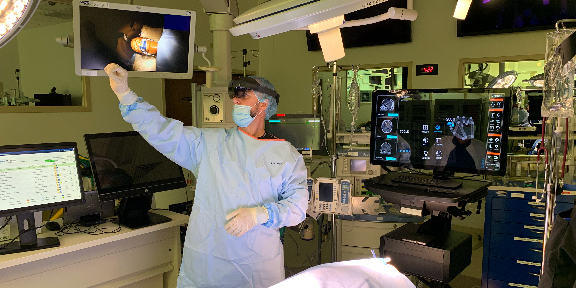 A clinician utilizing virtual reality technology in a mock surgery.